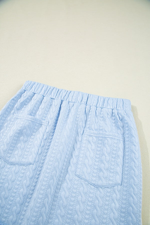 Light blue cable knit lounge pants with elastic waistband and two back pockets.
