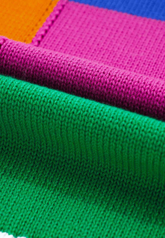 Patchwork knit crewneck pullover sweater in orange, pink, green, and blue acrylic blocks.