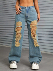 Medium wash distressed denim flare jeans with raw edge details and ripped knees.