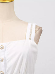 White midi dress with eyelet straps and pearl button detail