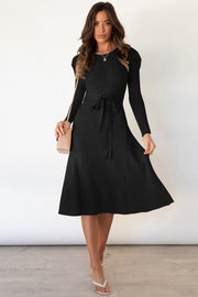 Black cable knit midi dress with long sleeves and self-tie belt