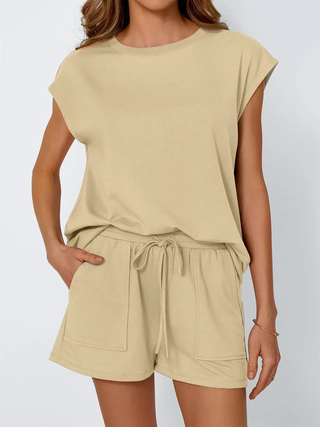 Tan cap-sleeve loungewear set with drawstring shorts and pocket detail.
