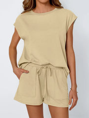Tan cap-sleeve loungewear set with drawstring shorts and pocket detail.