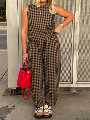 Gingham cropped tank and tapered trousers set in caramel and black, styled with a red handbag.
