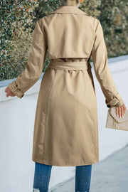 Classic trench coat in Dust Storm with a bow-tie waist and buttoned cuffs.