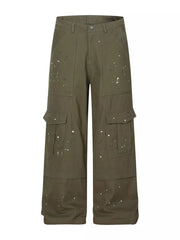 Olive green cotton cargo pants with white paint splatter design and button fly.
