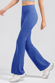 Royal blue flare leggings with a high waist, shown on a model walking.