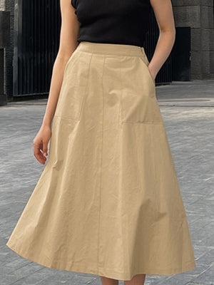 High-waisted A-line skirt in beige cotton with front pockets and a midi length.