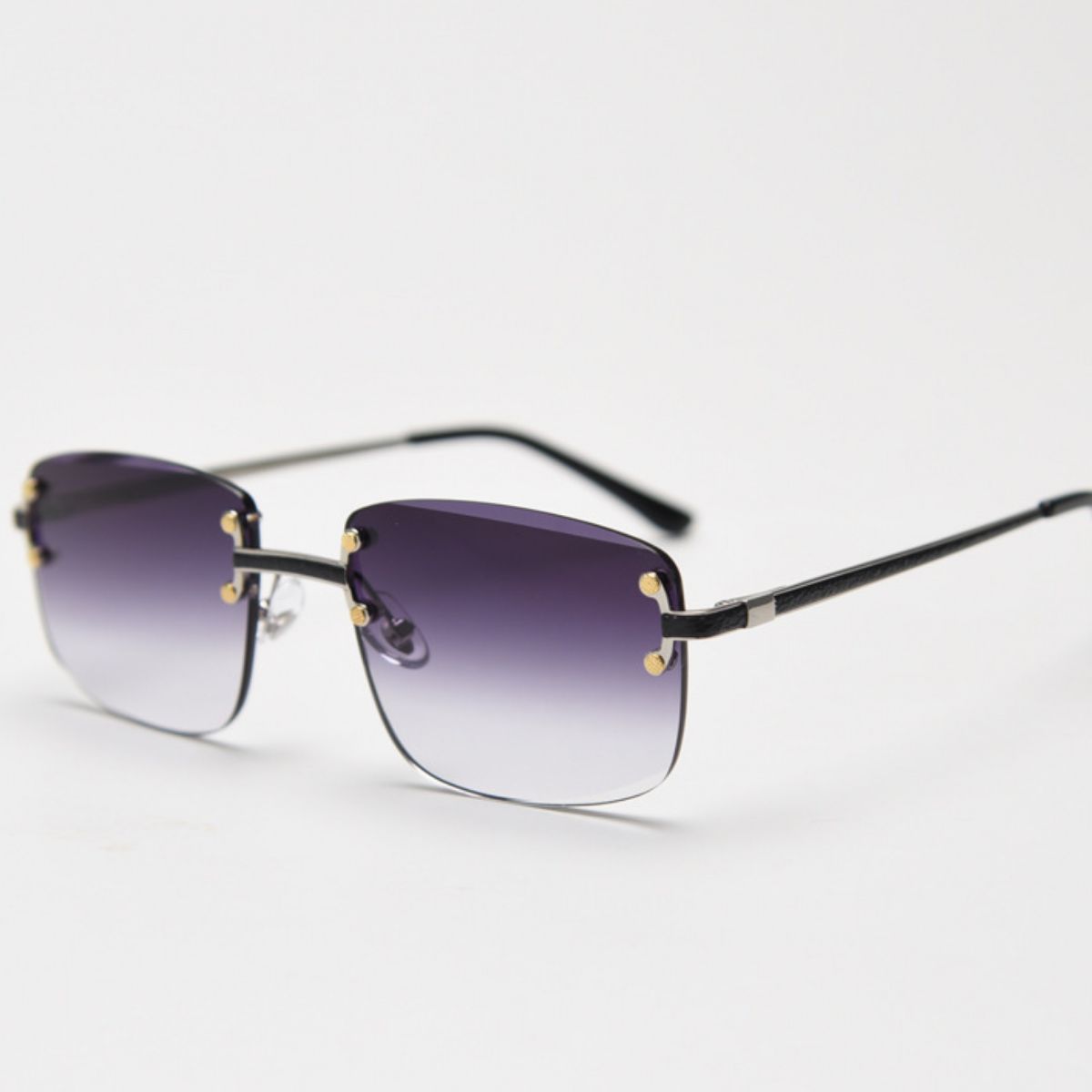 Rimless gradient tinted sunglasses with gold accents and black temples.