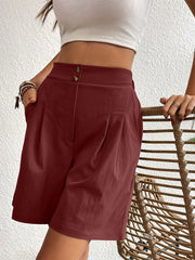 Burgundy pleated front bermuda shorts with double button waist and side pockets.