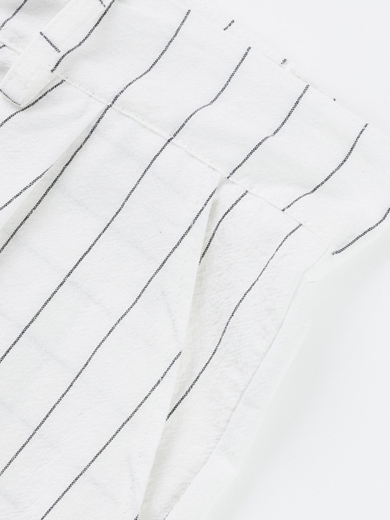 White striped men's sweatpants with a wide-leg cut and textured fabric detail.