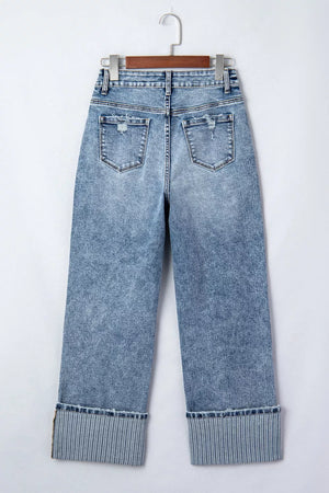 Maternity jeans in light wash denim with distressed details and striped cuffs.