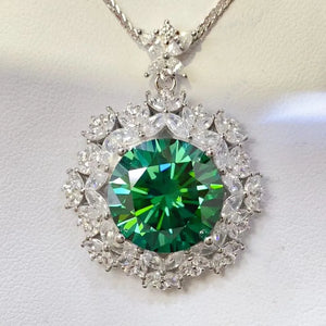 Emerald halo moissanite statement necklace in silver with a large green center stone and clear accent stones.