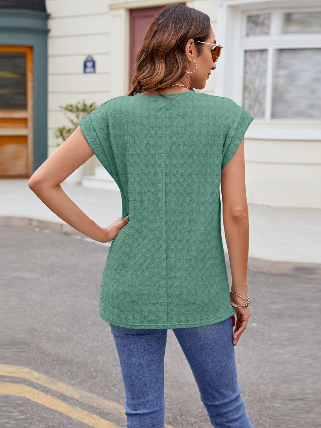 Green cap-sleeve tee with subtle knit texture and a relaxed fit.