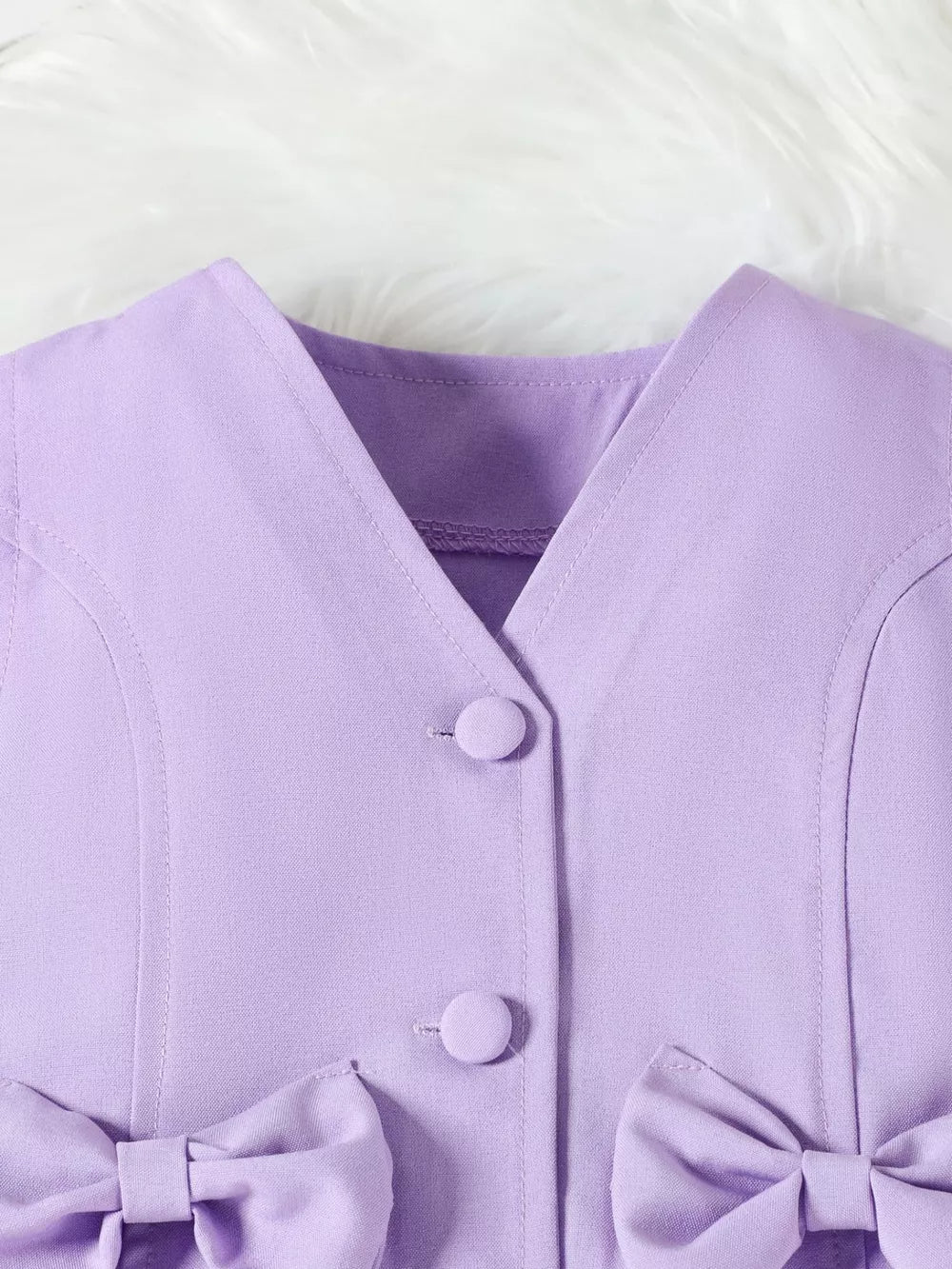 Purple baby vest with bowknot detail and button front