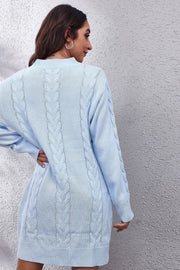 Light blue cable knit sweater dress with long sleeves and a mock neck.
