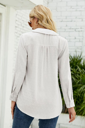 Textured collared blouse in light blue with a dotted pattern and button cuffs.