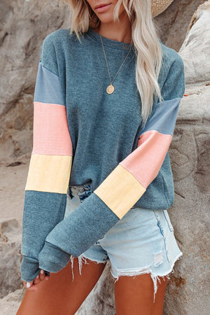 Colorblock sweatshirt with crewneck and long sleeves in gray, pink, and yellow accents.