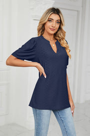 Dark navy perforated puff sleeve blouse with keyhole neckline.