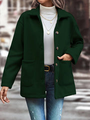 Oversized dark green shirt jacket with flap pockets and buttons.