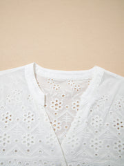 White cotton eyelet embroidered sheer shirt with floral details and a V-neck.