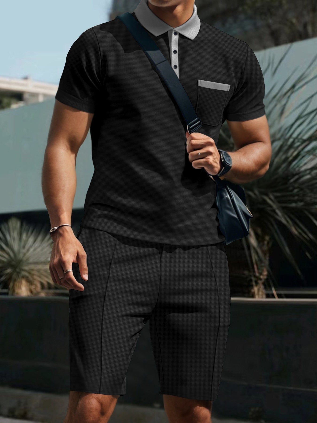 Black polo shirt and shorts set with grey collar and pocket detail