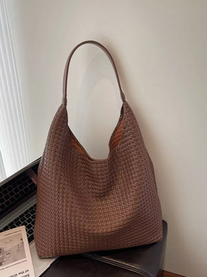 Brown woven straw texture tote bag with a single shoulder strap.