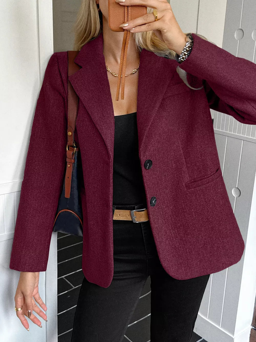 Chic burgundy blazer with lapel and buttoned front, featuring practical pockets.