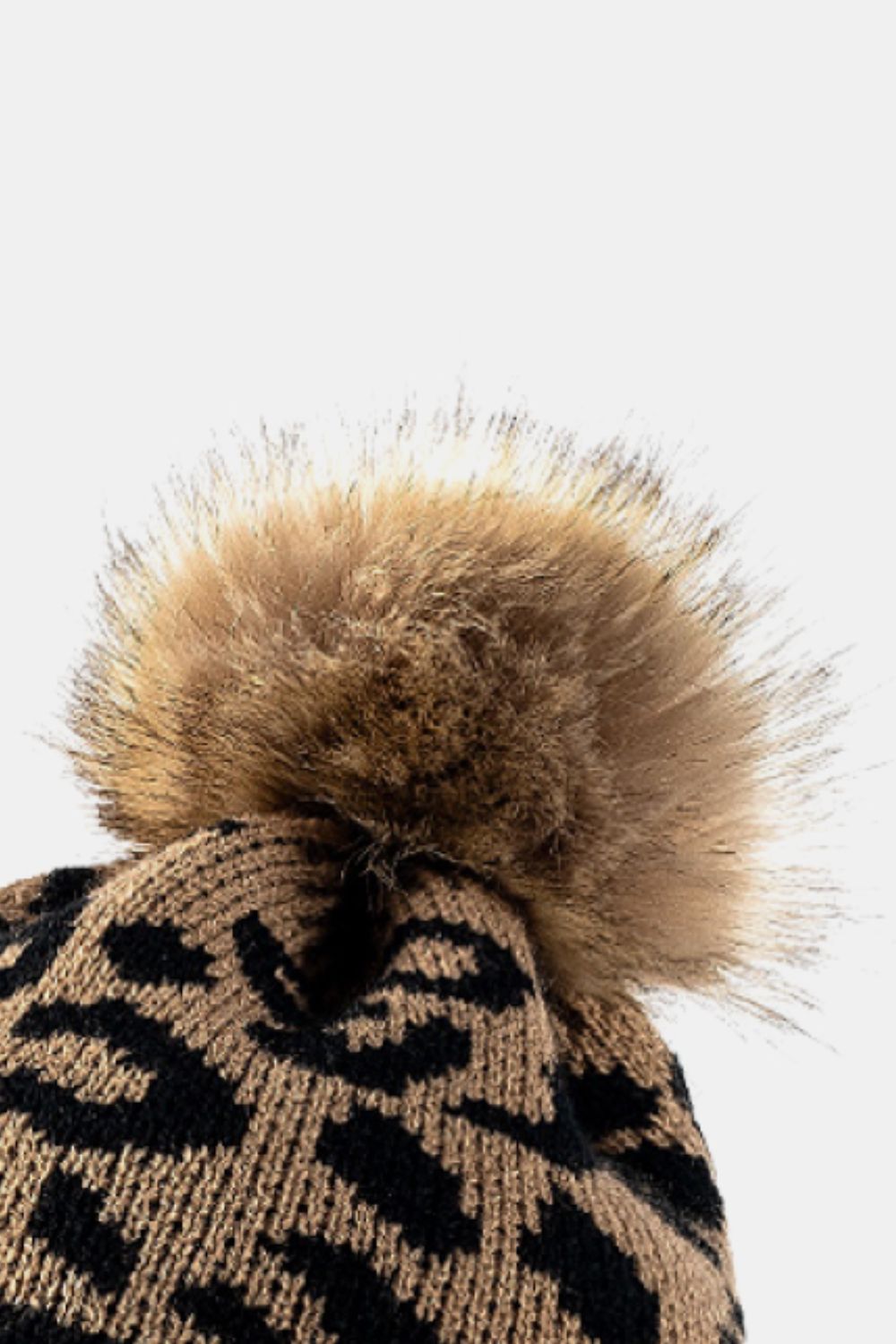 Beige acrylic beanie with black leopard print and a fluffy pom.