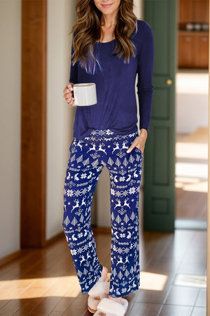 Navy lounge set with festive white reindeer and snowflake print, long sleeve top and wide leg pants.