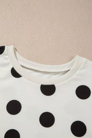 White polka dot loungewear set with crew neck top and bloused waist pants.