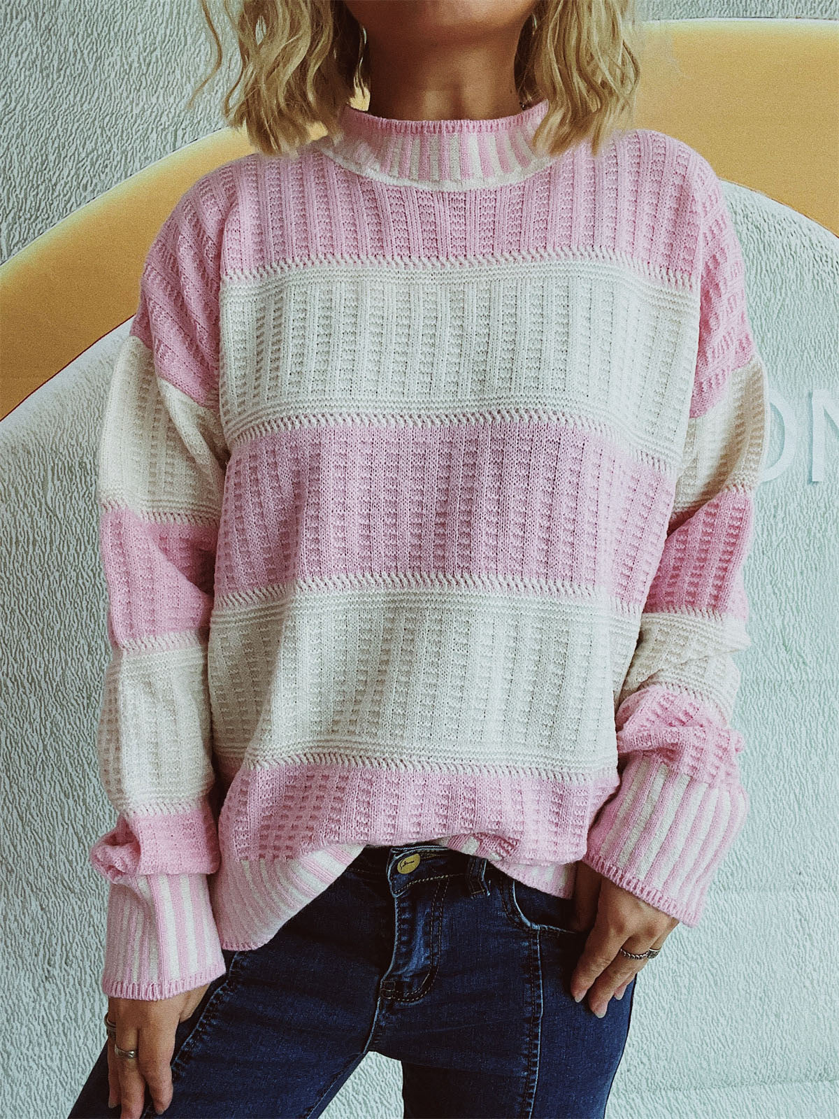 Textured stripe mock neck knit sweater in blush pink and cream with a relaxed fit.