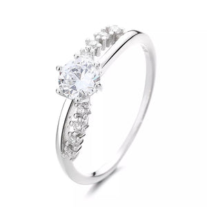 Sterling silver ring with round cubic zirconia and pave accents.