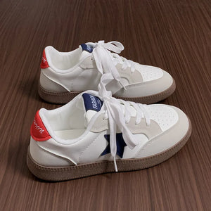 White retro sneakers with blue star appliqué and red heel detail.