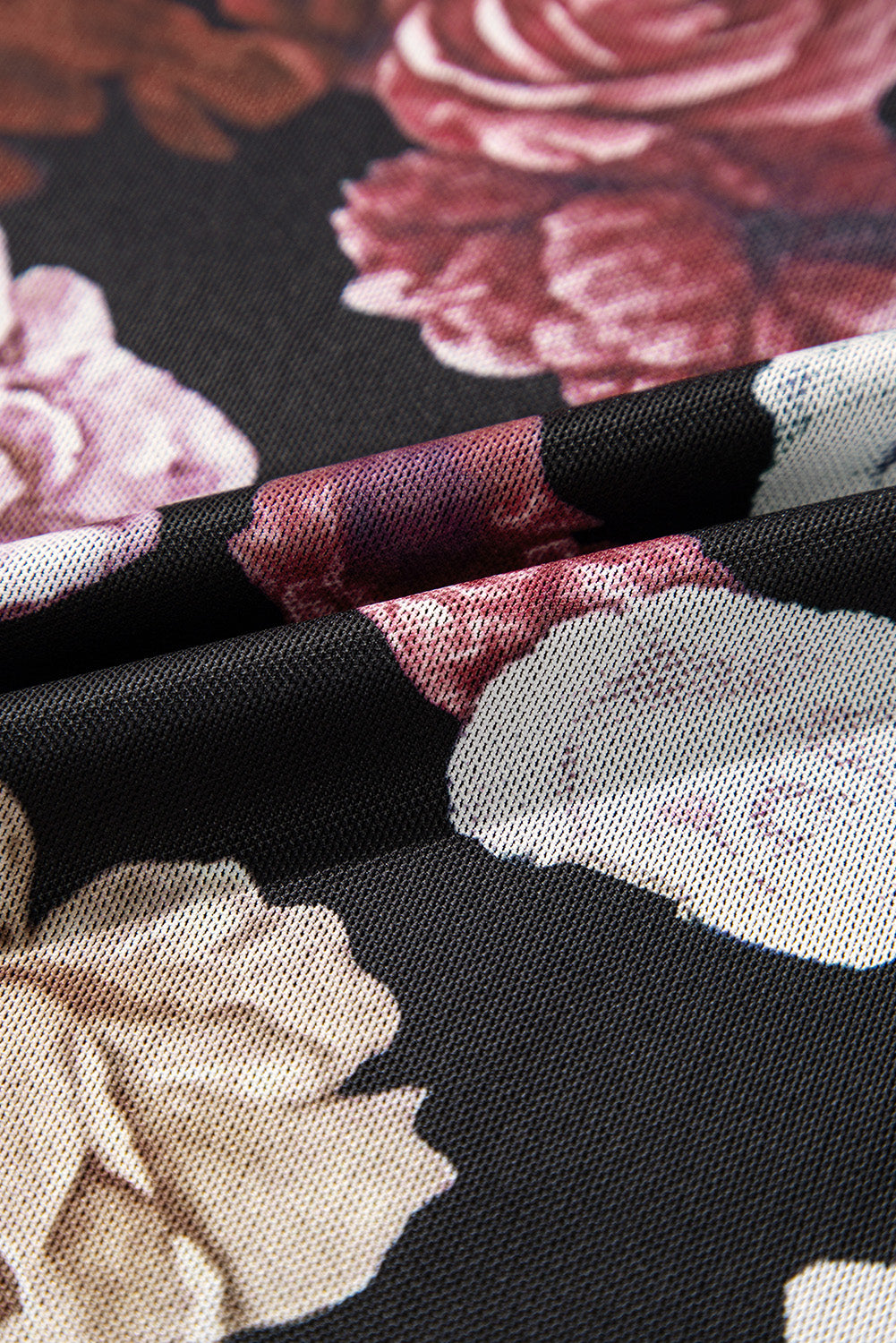 Black mesh blouse with a romantic floral print and a second-skin fit.