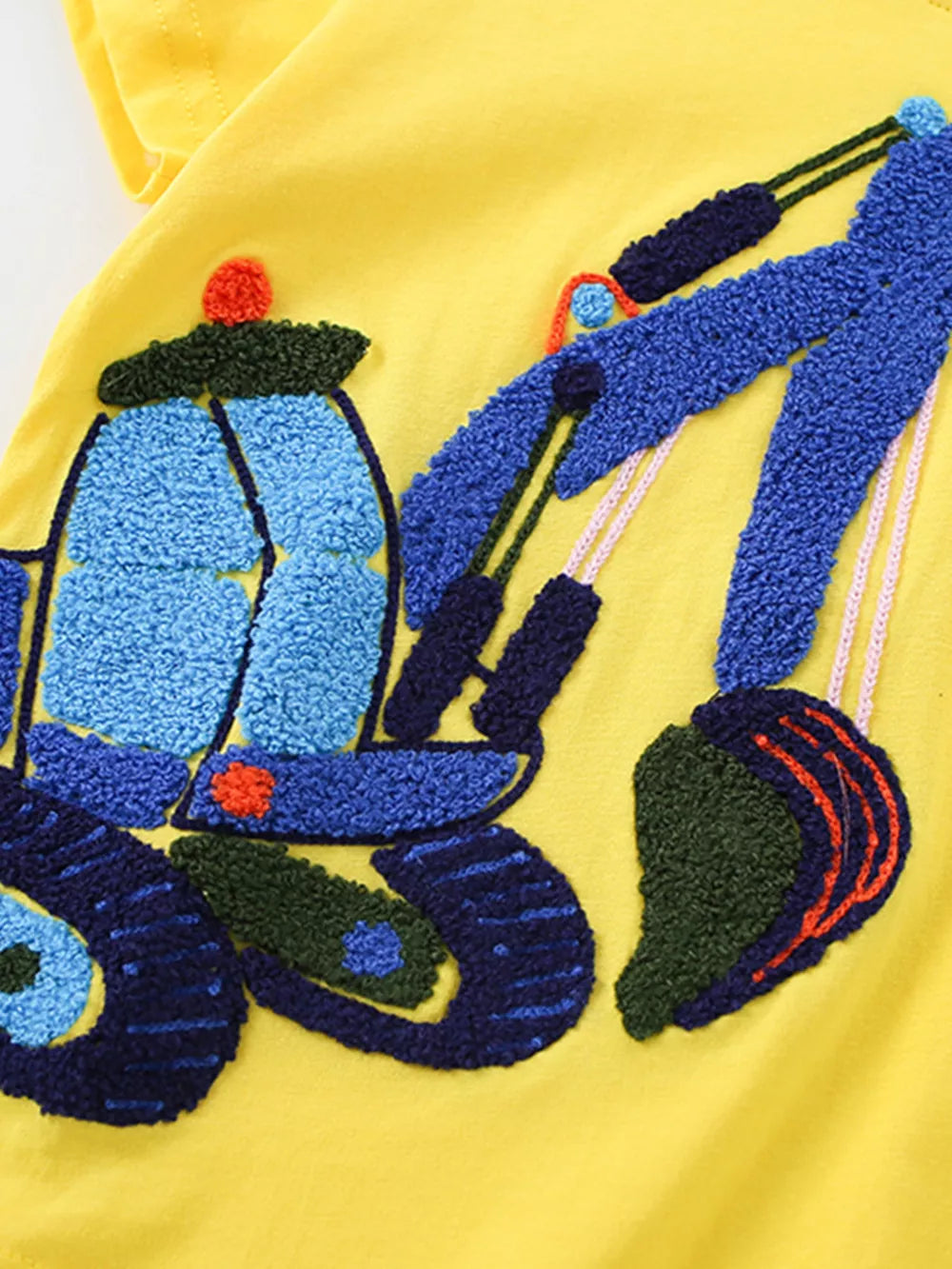 Yellow cotton t-shirt for kids with a textured blue excavator applique.