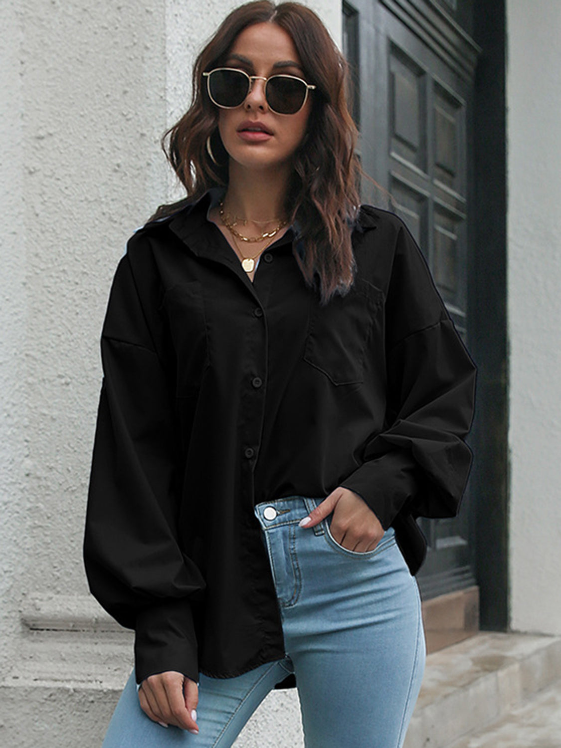 Black oversized poplin blouse with blouson sleeves and button front.