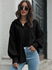 Black oversized poplin blouse with blouson sleeves and button front.