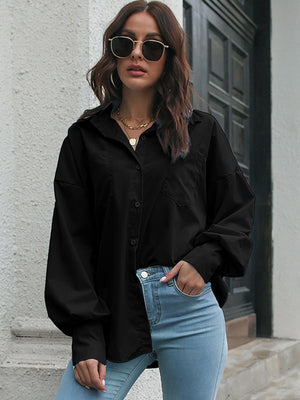 Black oversized poplin blouse with blouson sleeves and button front.