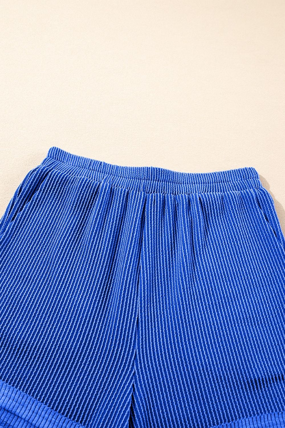 Royal blue textured ribbed shorts with elastic waistband and side pockets.