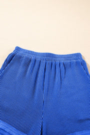 Royal blue textured ribbed shorts with elastic waistband and side pockets.