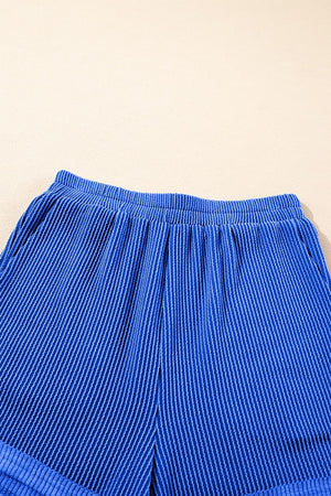 Royal blue textured ribbed shorts with elastic waistband and side pockets.