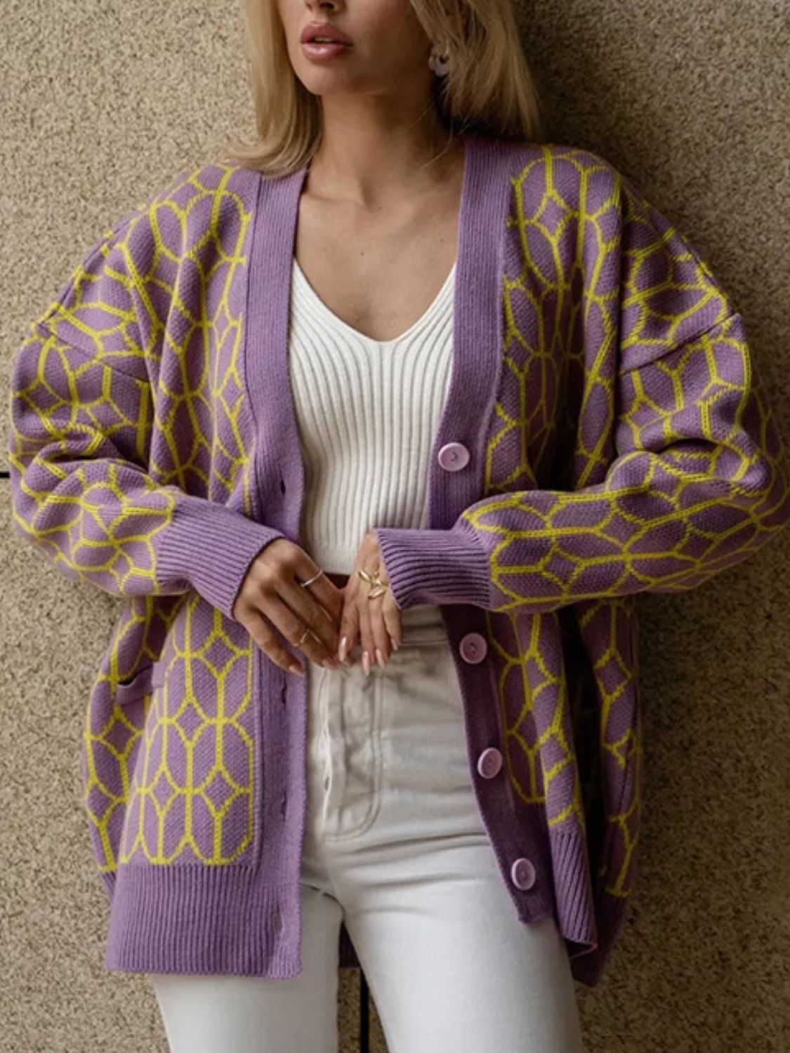 Geometric knit button-up cardigan in dusty pink with yellow pattern.