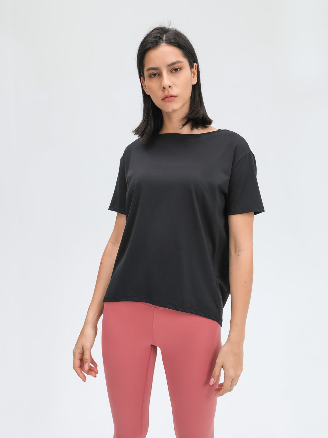 Black relaxed fit performance tee with boat neck and short sleeves.