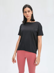 Black relaxed fit performance tee with boat neck and short sleeves.