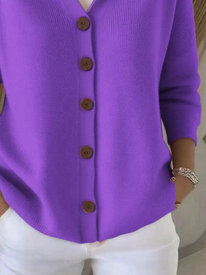 Purple button-front knit cardigan with wooden buttons and a ribbed texture.