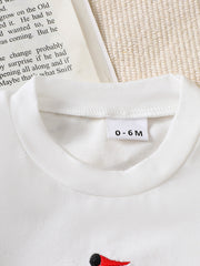 White cotton blend baby tee with sailboat appliqué and size tag