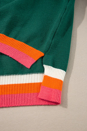 Dark green knit sweater with colorblock trim on sleeves and hem in pink, orange, and white stripes.