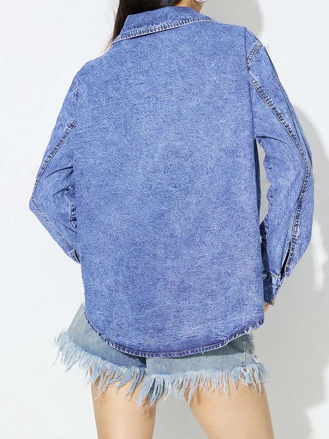 Acid wash denim overshirt in medium blue with a collar and long sleeves.