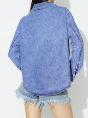 Acid wash denim overshirt in medium blue with a collar and long sleeves.